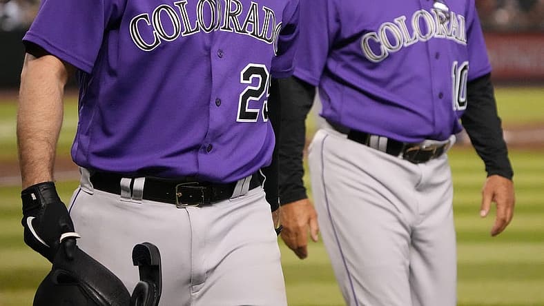 Jul 8, 2022; Phoenix, Arizona, USA; Colorado Rockies first baseman C.J. Cron (25) leaves the game alongside manager Bud Black (10) after being hit by a pitch against the Arizona Diamondbacks during the fifth inning at Chase Field. Mandatory Credit: Joe Camporeale-USA TODAY Sports