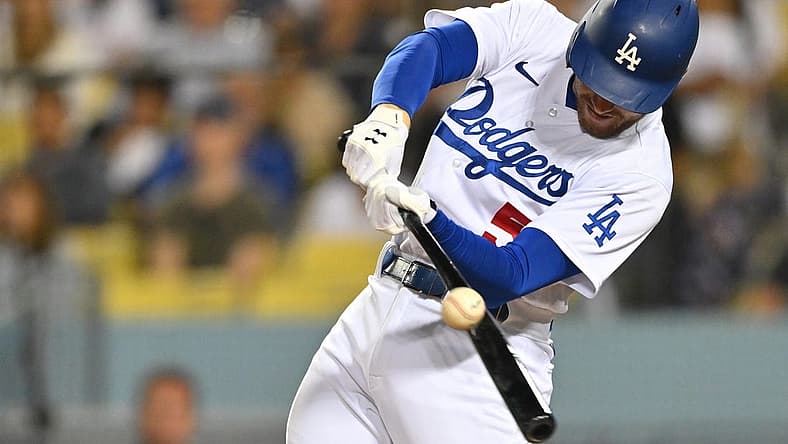 Jul 8, 2022; Los Angeles, California, USA; Los Angeles Dodgers first baseman Freddie Freeman (5) hits a double against the Chicago Cubs in the sixth inning at Dodger Stadium. Mandatory Credit: Jayne Kamin-Oncea-USA TODAY Sports