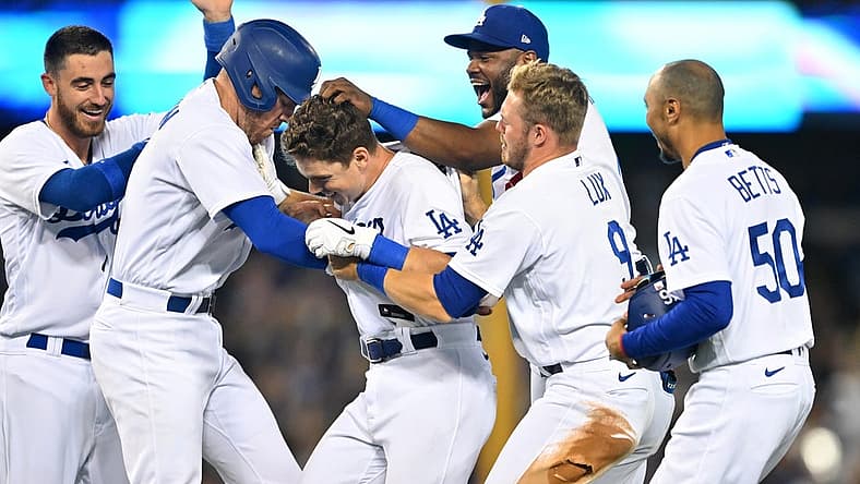 Jul 8, 2022; Los Angeles, California, USA; Los Angeles Dodgers catcher Will Smith (middle) is mobbed by center fielder Cody Bellinger (35), first baseman Freddie Freeman (5), second baseman Hanser Alberto (17), left fielder Gavin Lux (9) and right fielder Mookie Betts (50) after hitting a walk off RBI single to defeat the Chicago Cubs in the 10th inning at Dodger Stadium. Mandatory Credit: Jayne Kamin-Oncea-USA TODAY Sports