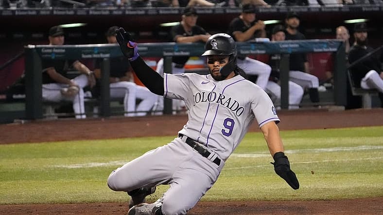 Jul 9, 2022; Phoenix, Arizona, USA; Colorado Rockies left fielder Connor Joe (9) slides and scores a run against the Arizona Diamondbacks during the third inning at Chase Field. Mandatory Credit: Joe Camporeale-USA TODAY Sports