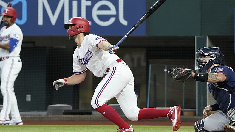 Jul 9, 2022; Arlington, Texas, USA; Texas Rangers third baseman Charlie Culberson (11) follows through on his single against the Minnesota Twins during the second inning at Globe Life Field. Mandatory Credit: Jim Cowsert-USA TODAY Sports