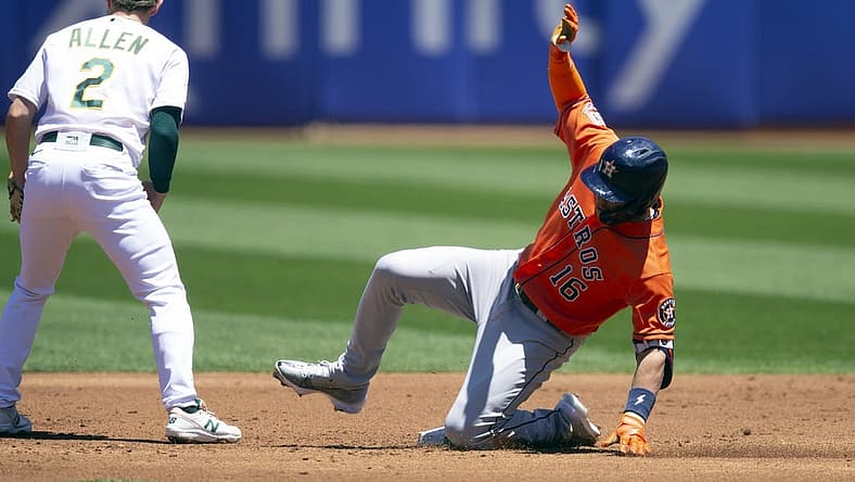 Jul 9, 2022; Oakland, California, USA; Houston Astros designated hitter Aledmys D az (16) slides safely into second base while Oakland Athletics second baseman Nick Allen (2) waits for the late relay during the second inning at RingCentral Coliseum. Mandatory Credit: D. Ross Cameron-USA TODAY Sports