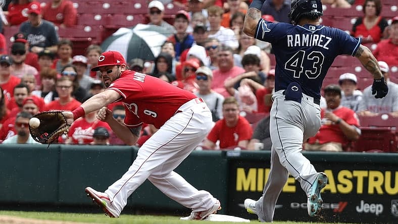 Jul 9, 2022; Cincinnati, Ohio, USA; Tampa Bay Rays left fielder Harold Ramirez (43) is out at first against Cincinnati Reds first baseman Mike Moustakas (9) during the first inning at Great American Ball Park. Mandatory Credit: David Kohl-USA TODAY Sports