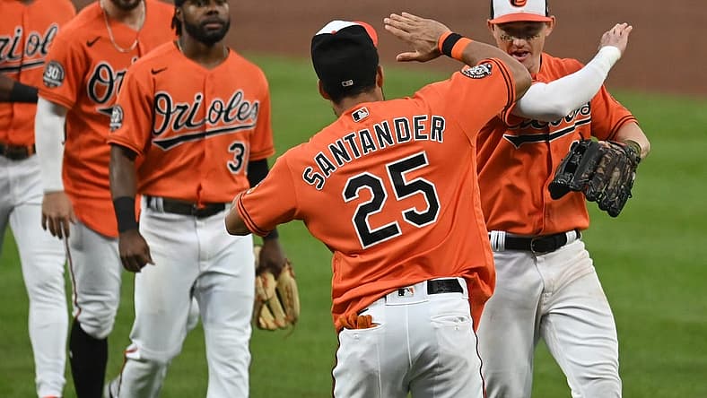 Jul 9, 2022; Baltimore, Maryland, USA; Baltimore Orioles right fielder Anthony Santander (25) celebrates with left fielder Austin Hays (21) and teammates after the game against the Los Angeles Angels at Oriole Park at Camden Yards. Mandatory Credit: Tommy Gilligan-USA TODAY Sports