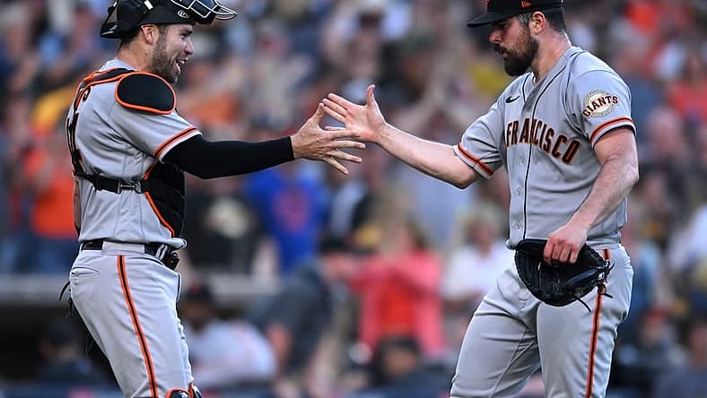 Jul 9, 2022; San Diego, California, USA; San Francisco Giants starting pitcher Carlos Rodon (right) celebrates with catcher Austin Wynns (left) after the Giants defeated the San Diego Padres at Petco Park. Mandatory Credit: Orlando Ramirez-USA TODAY Sports