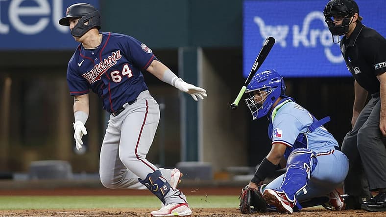 Jul 10, 2022; Arlington, Texas, USA; Minnesota Twins third baseman Jose Miranda (64) singles in a run against the Texas Rangers in the second inning at Globe Life Field. Mandatory Credit: Tim Heitman-USA TODAY Sports