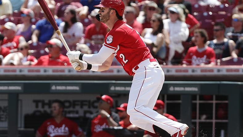 Jul 10, 2022; Cincinnati, Ohio, USA; Cincinnati Reds right fielder Tyler Naquin (12) hits a two-run double against the Tampa Bay Rays during the fourth inning at Great American Ball Park. Mandatory Credit: David Kohl-USA TODAY Sports