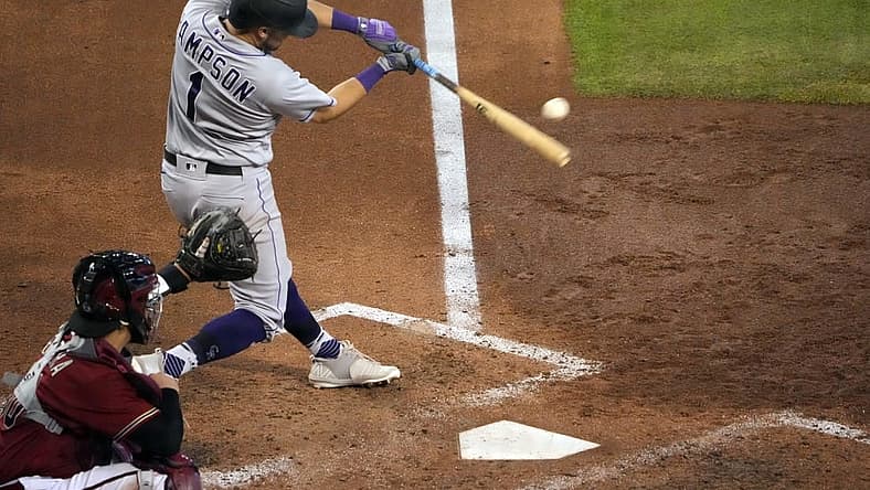 Jul 10, 2022; Phoenix, Arizona, USA; Colorado Rockies center fielder Garrett Hampson (1) hits a two-run RBI double against the Arizona Diamondbacks during the seventh inning at Chase Field. Mandatory Credit: Joe Camporeale-USA TODAY Sports
