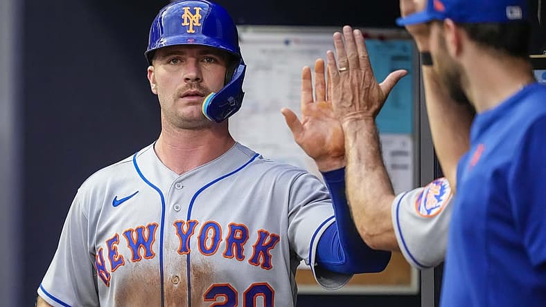 Jul 11, 2022; Cumberland, Georgia, USA; New York Mets first baseman Pete Alonso (20) gets a high five in the dugout after scoring a run against the Atlanta Braves during the third inning at Truist Park. Mandatory Credit: Dale Zanine-USA TODAY Sports