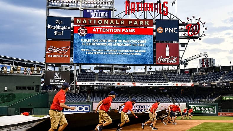 Jul 12, 2022; Washington, District of Columbia, USA; Washington Nationals grounds crew puts the tarp on the field before the game between the Washington Nationals and the Seattle Mariners at Nationals Park. Mandatory Credit: Brad Mills-USA TODAY Sports