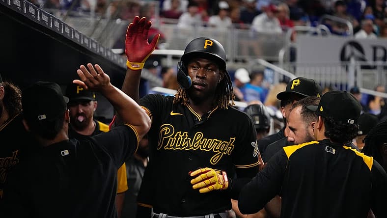 Jul 12, 2022; Miami, Florida, USA; Pittsburgh Pirates shortstop Oneil Cruz (15) celebrates in the dugout after scoring a run in the fifth inning against the Miami Marlins at loanDepot park. Mandatory Credit: Jasen Vinlove-USA TODAY Sports