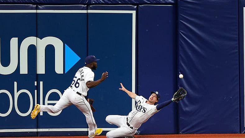 Jul 12, 2022; St. Petersburg, Florida, USA; Tampa Bay Rays shortstop Taylor Walls (right) dives for a ball in the fifth inning against the Boston Red Sox at Tropicana Field. Mandatory Credit: Nathan Ray Seebeck-USA TODAY Sports