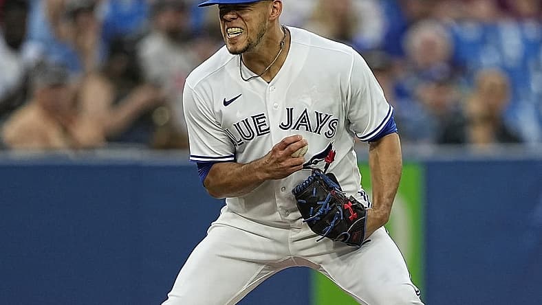 Jul 12, 2022; Toronto, Ontario, CAN; Toronto Blue Jays pitcher Jose Berrios (17) reacts after not being able to make a play on a ball bunted by Philadelphia Phillies catcher Garrett Stubbs (not pictured) during the fifth inning at Rogers Centre. Mandatory Credit: John E. Sokolowski-USA TODAY Sports