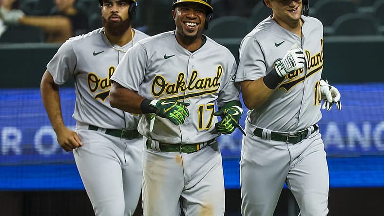 Jul 12, 2022; Arlington, Texas, USA; Oakland Athletics left fielder Chad Pinder (10) celebrates with Oakland Athletics third baseman Dermis Garcia (76) and Oakland Athletics shortstop Elvis Andrus (17) after hitting a grand slam home run during the twelfth inning against the Texas Rangers at Globe Life Field. Mandatory Credit: Kevin Jairaj-USA TODAY Sports