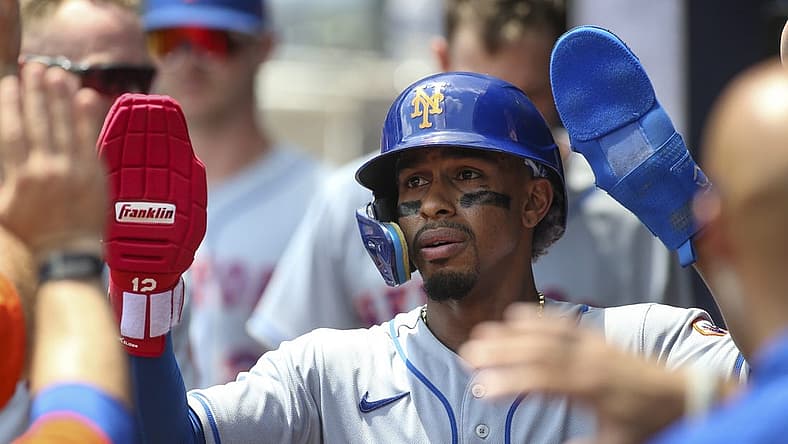 Jul 13, 2022; Atlanta, Georgia, USA; New York Mets shortstop Francisco Lindor (12) celebrates after scoring a run against the Atlanta Braves in the seventh inning at Truist Park. Mandatory Credit: Brett Davis-USA TODAY Sports