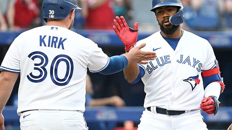 Jul 13, 2022; Toronto, Ontario, CAN; Toronto Blue Jays right fielder Teoscar Hernandez (right) is greeted at home plate by catcher Alejandro Kirk (30) after hitting a two-run home run against the Philadelphia Phillies in the fourth inning at Rogers Centre. Mandatory Credit: Dan Hamilton-USA TODAY Sports