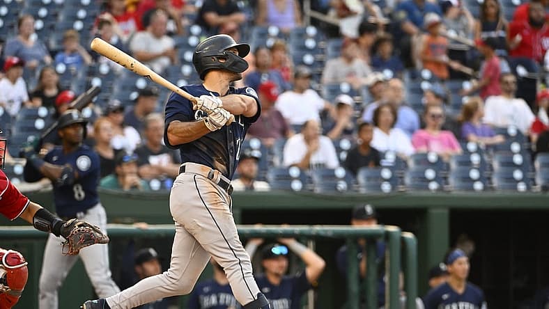 Jul 13, 2022; Washington, District of Columbia, USA; Seattle Mariners second baseman Adam Frazier (26) hits an RBI sacrifice fly against the Washington Nationals during the sixth inning at Nationals Park. Mandatory Credit: Brad Mills-USA TODAY Sports