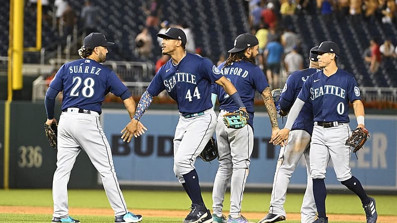 Jul 13, 2022; Washington, District of Columbia, USA; Seattle Mariners center fielder Julio Rodriguez (44) and third baseman Eugenio Suarez (28) and right fielder Sam Haggerty (0) celebrate after the game against the Washington Nationals at Nationals Park. Mandatory Credit: Brad Mills-USA TODAY Sports