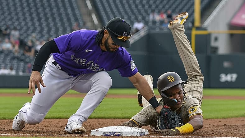 Jul 13, 2022; Denver, Colorado, USA; San Diego Padres shortstop C.J. Abrams (right) is picked off at first base by Colorado Rockies first baseman Connor Joe (left) in the second inning at Coors Field. Mandatory Credit: John Leyba-USA TODAY Sports