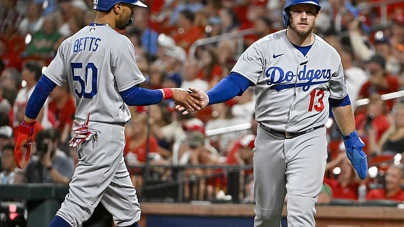 Jul 13, 2022; St. Louis, Missouri, USA; Los Angeles Dodgers third baseman Max Muncy (13) celebrates with right fielder Mookie Betts (50) after they both scored on a single by shortstop Trea Turner (not pictured) against the St. Louis Cardinals during the eighth inning at Busch Stadium. Mandatory Credit: Jeff Curry-USA TODAY Sports