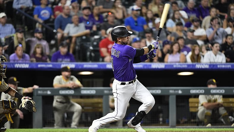 Jul 13, 2022; Denver, Colorado, USA; Colorado Rockies shortstop Jose Iglesias (11) hits a two run RBI in the seventh inning against the San Diego Padres at Coors Field. Iglesias ended the game with a 6 RBI night. Mandatory Credit: John Leyba-USA TODAY Sports