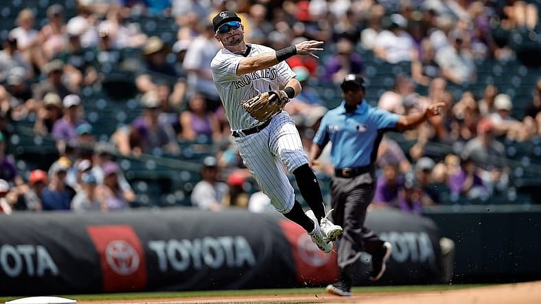 Jul 14, 2022; Denver, Colorado, USA; Colorado Rockies third baseman Garrett Hampson (1) makes a throw to first for an out in the first inning against the San Diego Padres at Coors Field. Mandatory Credit: Isaiah J. Downing-USA TODAY Sports