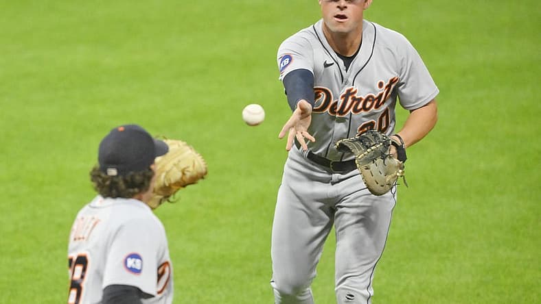 Jul 14, 2022; Cleveland, Ohio, USA; Detroit Tigers first baseman Spencer Torkelson (20) tosses the ball to relief pitcher Jason Foley (68) in the seventh inning against the Cleveland Guardians at Progressive Field. Mandatory Credit: David Richard-USA TODAY Sports