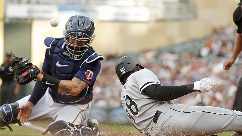 Jul 15, 2022; Minneapolis, Minnesota, USA; Chicago White Sox center fielder Luis Robert (88) scores from second base past Minnesota Twins catcher Gary Sanchez (24) in the first inning at Target Field. Mandatory Credit: Bruce Kluckhohn-USA TODAY Sports