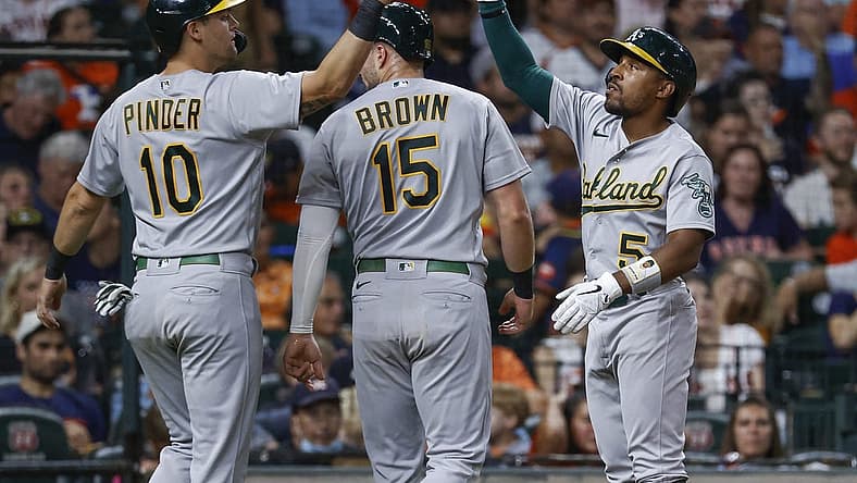 Jul 15, 2022; Houston, Texas, USA; Oakland Athletics left fielder Tony Kemp (5) celebrates with designated hitter Chad Pinder (10) and first baseman Seth Brown (15) during the seventh inning against the Houston Astros at Minute Maid Park. Mandatory Credit: Troy Taormina-USA TODAY Sports