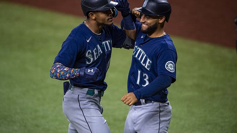 Jul 15, 2022; Arlington, Texas, USA; Seattle Mariners center fielder Julio Rodriguez (44) and second baseman Abraham Toro (13) celebrate a grand slam home run hit by Rodriguez against the Texas Rangers during the eighth inning at Globe Life Field. Mandatory Credit: Jerome Miron-USA TODAY Sports