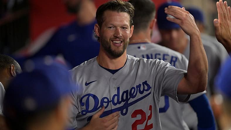 Jul 15, 2022; Anaheim, California, USA; Los Angeles Dodgers starting pitcher Clayton Kershaw (22) is congratulated in the dugout following the eighth inning against the Los Angeles Angels at Angel Stadium. Mandatory Credit: Jayne Kamin-Oncea-USA TODAY Sports