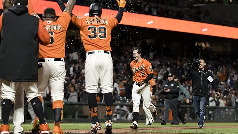 Jul 15, 2022; San Francisco, California, USA; San Francisco Giants right fielder Mike Yastrzemski (5) celebrates with teammates after he hit a grand slam for a walkoff win against the Milwaukee Brewers at Oracle Park. Mandatory Credit: John Hefti-USA TODAY Sports