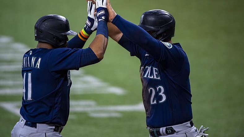 Jul 16, 2022; Arlington, Texas, USA; Seattle Mariners designated hitter Carlos Santana (41) and first baseman Ty France (23) celebrate the two run home run hit by Santana against the Texas Rangers during the third inning at Globe Life Field. Mandatory Credit: Jerome Miron-USA TODAY Sports
