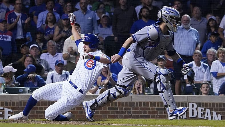 Jul 16, 2022; Chicago, Illinois, USA; Chicago Cubs third baseman Patrick Wisdom (16) scores as New York Mets catcher Tomas Nido (3) waits for a late throw during the fourth inning in game two of a doubleheader at Wrigley Field. Mandatory Credit: David Banks-USA TODAY Sports
