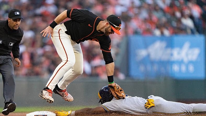 Jul 16, 2022; San Francisco, California, USA; San Francisco Giants third baseman Evan Longoria (10) tags out Milwaukee Brewers center fielder Jonathan Davis (3) at Oracle Park. Mandatory Credit: Stan Szeto-USA TODAY Sports