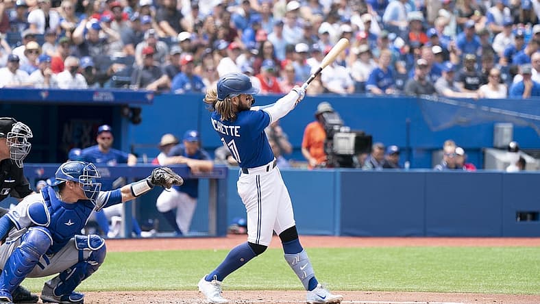 Jul 17, 2022; Toronto, Ontario, CAN; Toronto Blue Jays shortstop Bo Bichette (11) hits a sacrifice fly ball scoring a run against the Kansas City Royals during the third inning at Rogers Centre. Mandatory Credit: Nick Turchiaro-USA TODAY Sports