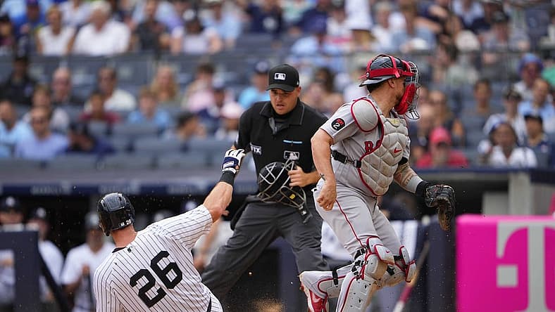 Jul 17, 2022; Bronx, New York, USA; New York Yankees second baseman DJ LeMahieu (26) scores a run on an errant throw to Boston Red Sox catcher Christian Vazquez (7) during the first inning at Yankee Stadium. Mandatory Credit: Gregory Fisher-USA TODAY Sports