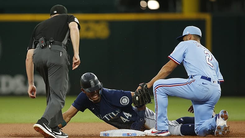 Jul 17, 2022; Arlington, Texas, USA; Texas Rangers second baseman Marcus Semien (2) tags out Seattle Mariners center fielder Julio Rodriguez (44) as he attempts to steal second base in the first inning at Globe Life Field. Mandatory Credit: Tim Heitman-USA TODAY Sports