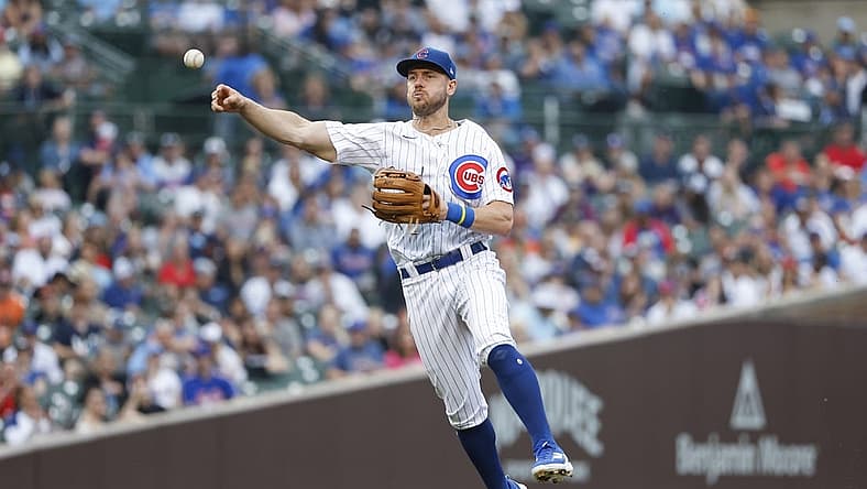 Jul 17, 2022; Chicago, Illinois, USA; Chicago Cubs third baseman Patrick Wisdom (16) throws to first base for a New York Mets out during the fourth inning at Wrigley Field. Mandatory Credit: Kamil Krzaczynski-USA TODAY Sports