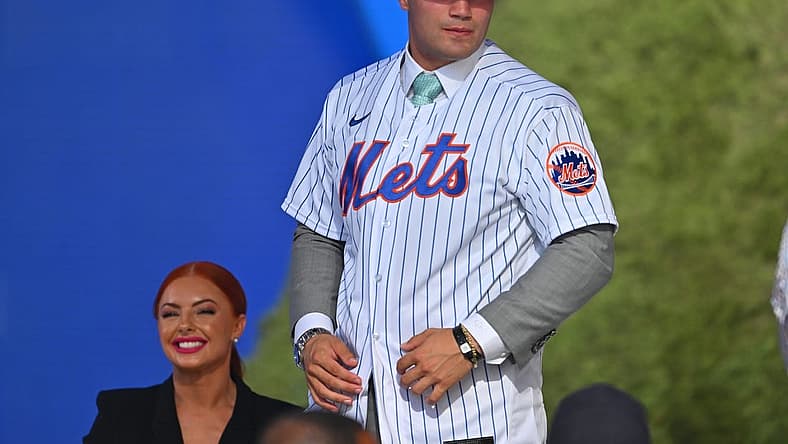 Jul 17, 2022; Los Angeles, CA, USA; Kevin Parada puts on a jersey after he was selected by the New York Mets as the 11th player in the MLB draft at XBox Plaza at LA Live. Mandatory Credit: Jayne Kamin-Oncea-USA TODAY Sports