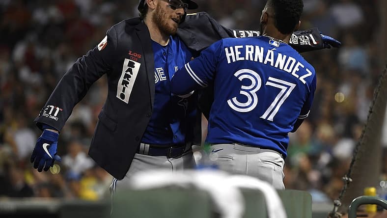 Jul 22, 2022; Boston, Massachusetts, USA; Toronto Blue Jays right fielder Teoscar Hernandez (37) puts a jacket on catcher Danny Jansen (9) after hitting a home run during the fourth inning against the Boston Red Sox at Fenway Park. Mandatory Credit: Bob DeChiara-USA TODAY Sports