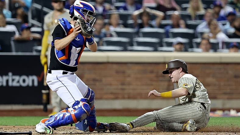 Jul 22, 2022; New York City, New York, USA; San Diego Padres second baseman Jake Cronenworth (9) scores ahead of the tag by New York Mets catcher Patrick Mazeika (4) on a fielder's choice by Padres right fielder Nomar Mazara (not pictured) and error by Mazeika during the seventh inning at Citi Field. Mandatory Credit: Brad Penner-USA TODAY Sports