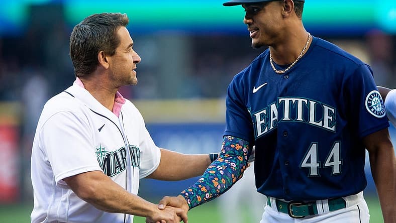 Jul 22, 2022; Seattle, Washington, USA; Former Seattle Mariners player Bret Boone shakes hands with Seattle Mariners center fielder Julio Rodriguez (44) after the ceremonial first pitch before the game against the Houston Astros at T-Mobile Park. Mandatory Credit: Lindsey Wasson-USA TODAY Sports