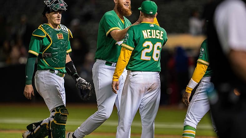 Jul 22, 2022; Oakland, California, USA; Oakland Athletics relief pitcher A.J. Puk (33) celebrates with Oakland Athletics designated hitter Sheldon Neuse (26) after the game against the Texas Rangers at RingCentral Coliseum. Mandatory Credit: Neville E. Guard-USA TODAY Sports