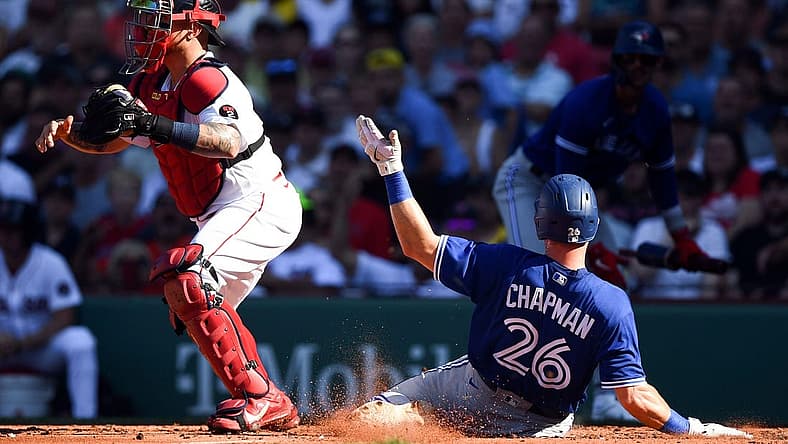 Jul 23, 2022; Boston, Massachusetts, USA; Toronto Blue Jays third baseman Matt Chapman (26) slides safely into home scoring a run in front of Boston Red Sox catcher Christian Vazquez (7) during the third inning at Fenway Park. Mandatory Credit: Brian Fluharty-USA TODAY Sports