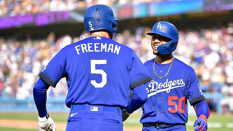 Jul 23, 2022; Los Angeles, California, USA; Los Angeles Dodgers right fielder Mookie Betts (50) is greeted by first baseman Freddie Freeman (5) after hitting a solo home run against the San Francisco Giants during the third inning at Dodger Stadium. Mandatory Credit: Gary A. Vasquez-USA TODAY Sports