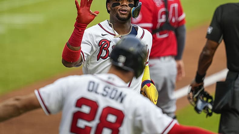 Jul 23, 2022; Cumberland, Georgia, USA; Atlanta Braves right fielder Ronald Acuna Jr. (13) reacts with first baseman Matt Olson (28) after scoring a run against the Los Angeles Angels during the first inning at Truist Park. Mandatory Credit: Dale Zanine-USA TODAY Sports