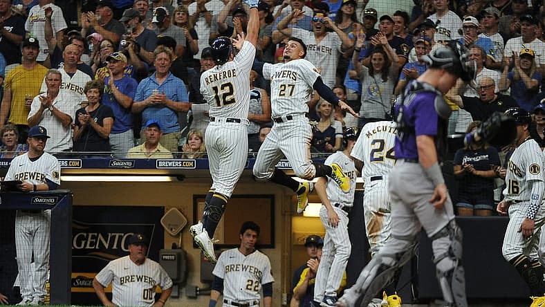 Jul 23, 2022; Milwaukee, Wisconsin, USA; Milwaukee Brewers right fielder Hunter Renfroe (12) celebrates with shortstop Willy Adames (27) after hitting a home run against Colorado Rockies in the fourth inning at American Family Field. Mandatory Credit: Michael McLoone-USA TODAY Sports
