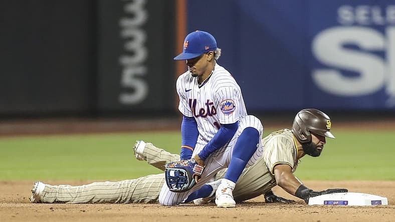 Jul 23, 2022; New York City, New York, USA; New York Mets shortstop Francisco Lindor (12) holds onto the ball after a pick off attempt against San Diego Padres right fielder Nomar Mazara (16) in the fifth inning at Citi Field. Mandatory Credit: Wendell Cruz-USA TODAY Sports