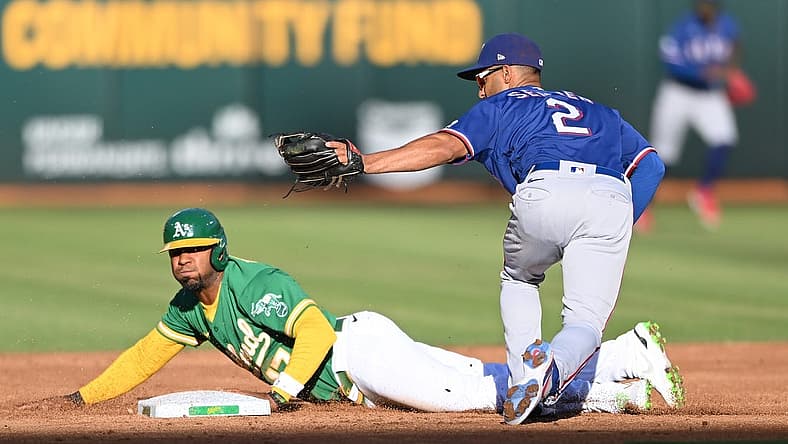 Jul 23, 2022; Oakland, California, USA; Texas Rangers second baseman Marcus Semien (2) tags out Oakland Athletics shortstop Elvis Andrus (17) on a steal attempt during the second inning at RingCentral Coliseum. Mandatory Credit: Robert Edwards-USA TODAY Sports